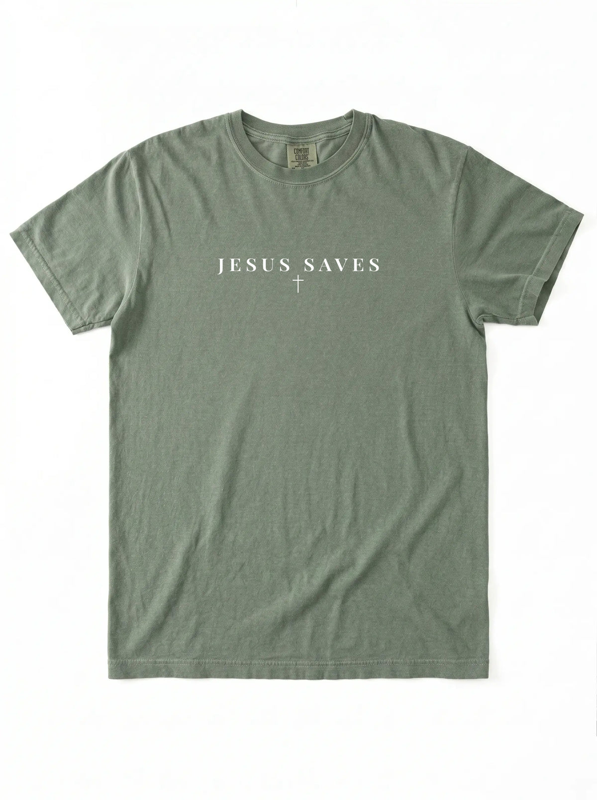 Sage green short-sleeve T-shirt laid flat on a white background, featuring white “JESUS SAVES” text with a small cross printed below.