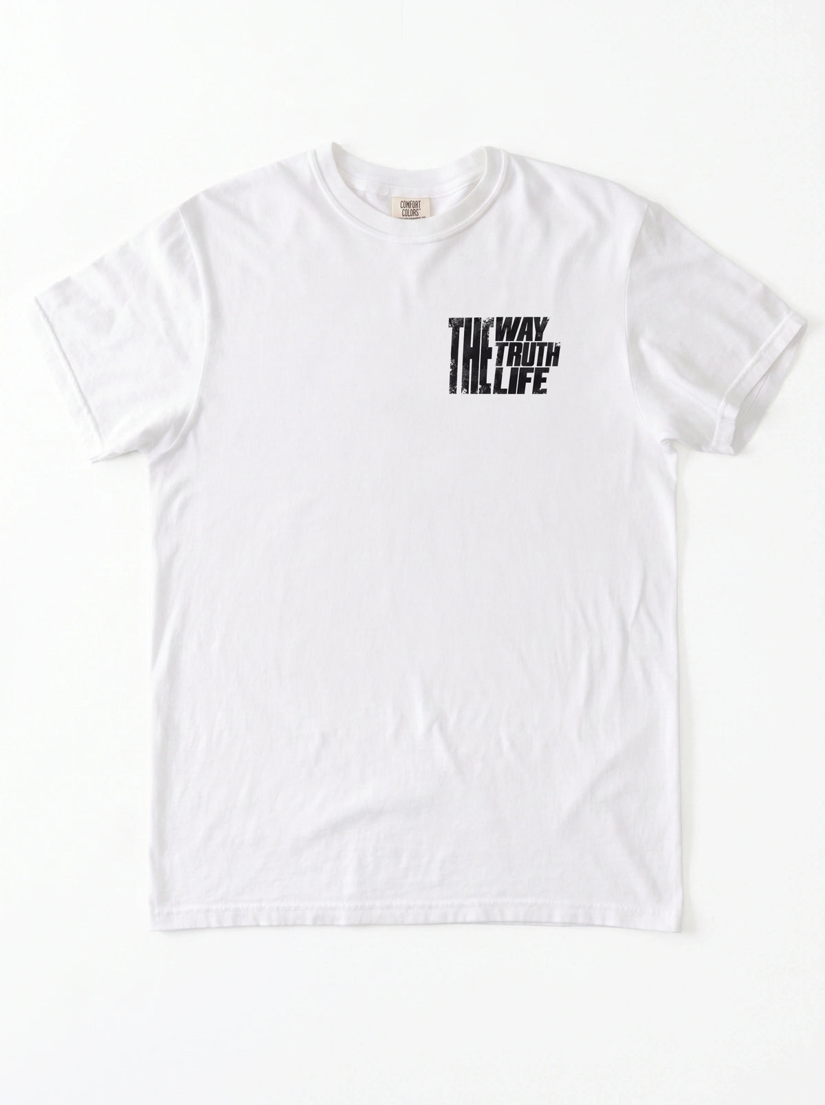 White T-shirt laid flat with a small distressed chest print reading “The Way The Truth The Life.”