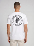 A man viewed from the back wearing a white short-sleeve t-shirt with a large black circular graphic on the back featuring a gladiator helmet and the text 'SALVATION & SPIRIT' and 'EPHESIANS 6:17'.