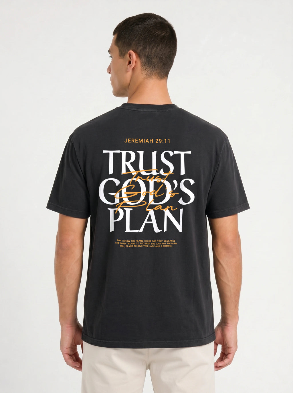 Person wearing a black T-shirt with a large back design reading “JEREMIAH 29:11” and “TRUST GOD’S PLAN,” with the verse printed below.