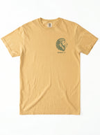 A light tan crewneck t-shirt featuring a dark green graphic of a green lion graphic and 'JEREMIAH 17:7' text on the left chest, displayed flat against a white background.
