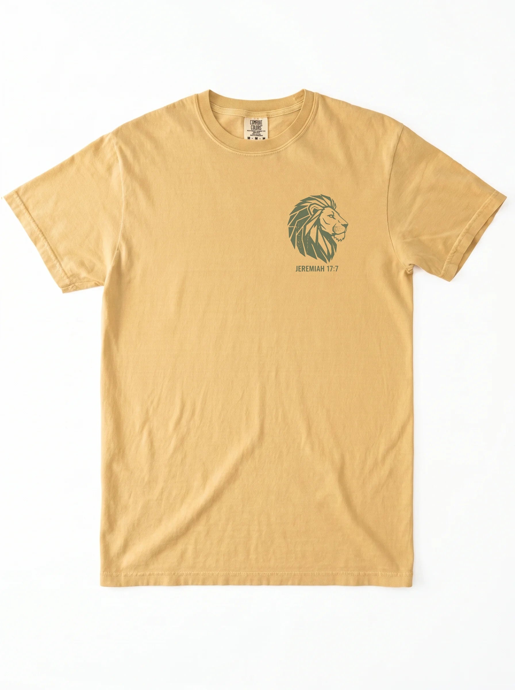 A light tan crewneck t-shirt featuring a dark green graphic of a green lion graphic and 'JEREMIAH 17:7' text on the left chest, displayed flat against a white background.
