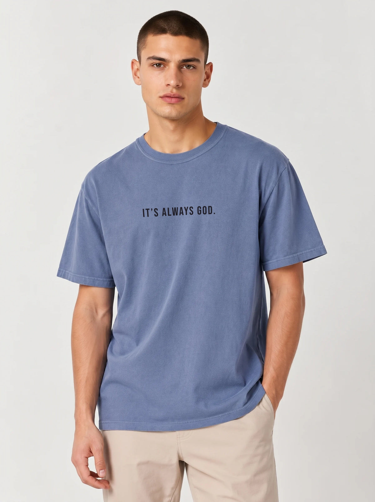 Person wearing a faded blue T-shirt with the black text “It’s Always God.”