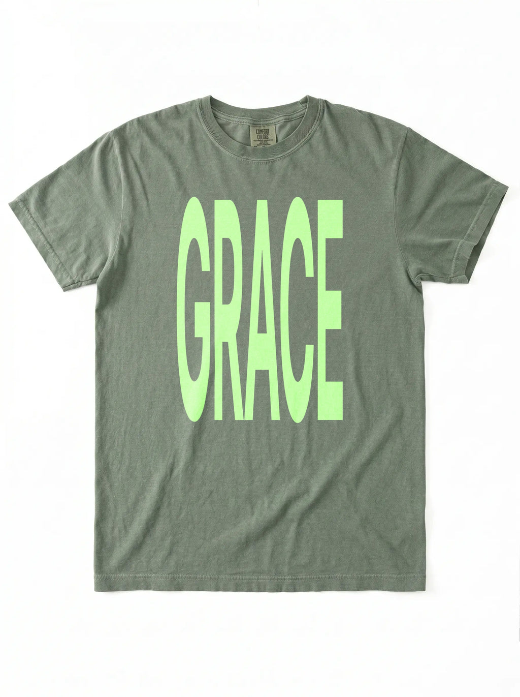 Muted green T-shirt laid flat with large neon green text reading “GRACE.”