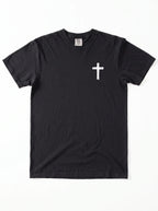 A black short-sleeve crewneck t-shirt with a small white distressed cross printed on the left chest, displayed flat against a white background.