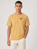 Person wearing a yellow T-shirt with black “1 John 4:4” text and a cross printed on the chest.