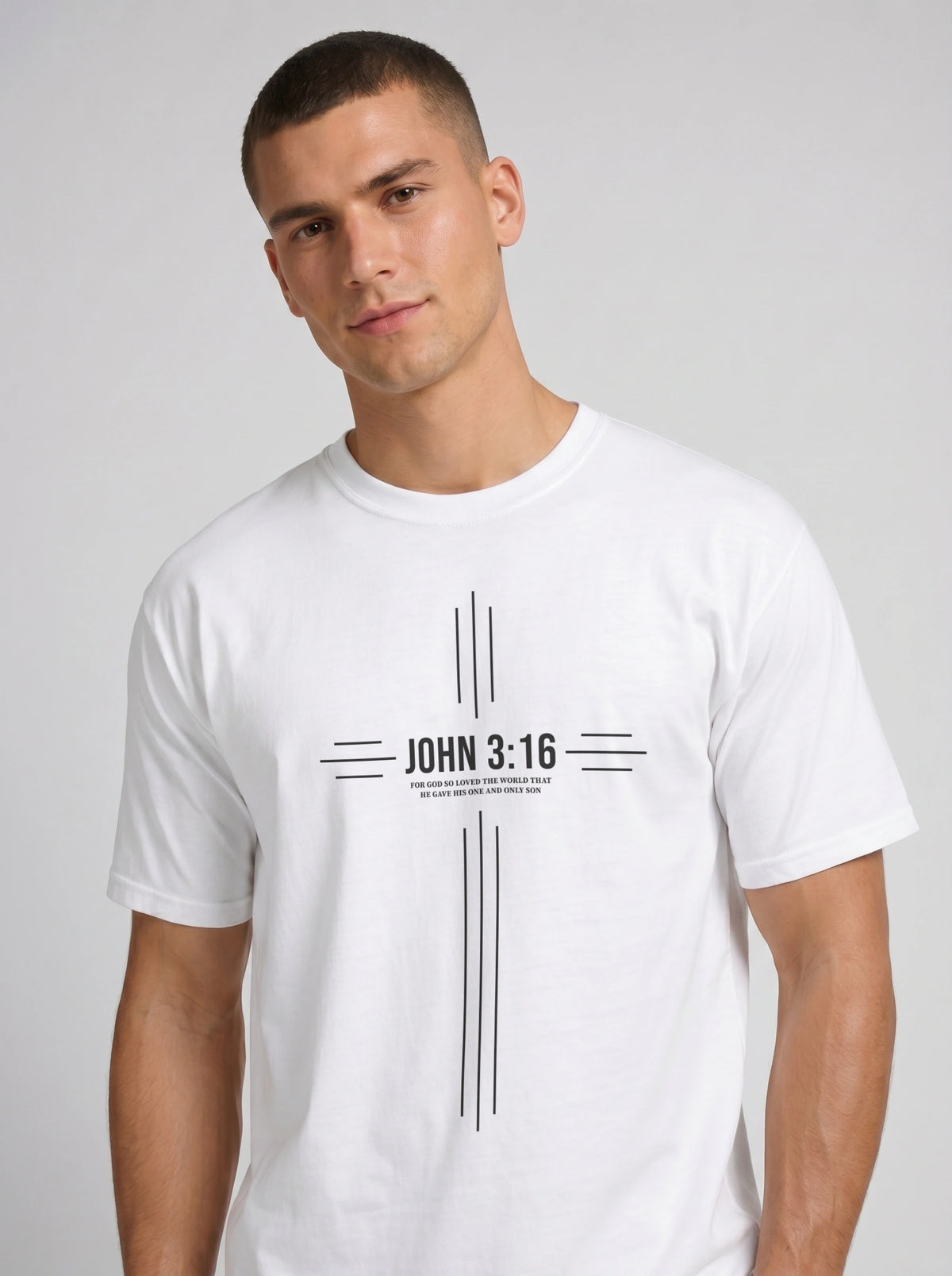 Person wearing a white T-shirt with a black cross-shaped design reading “John 3:16” and “For God so loved the world that he gave his one and only son.”