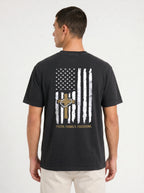 A man wearing a black t-shirt from the back, featuring a distressed white and gold American flag graphic with a cross and the text 'FAITH, FAMILY, FREEDOM.'.