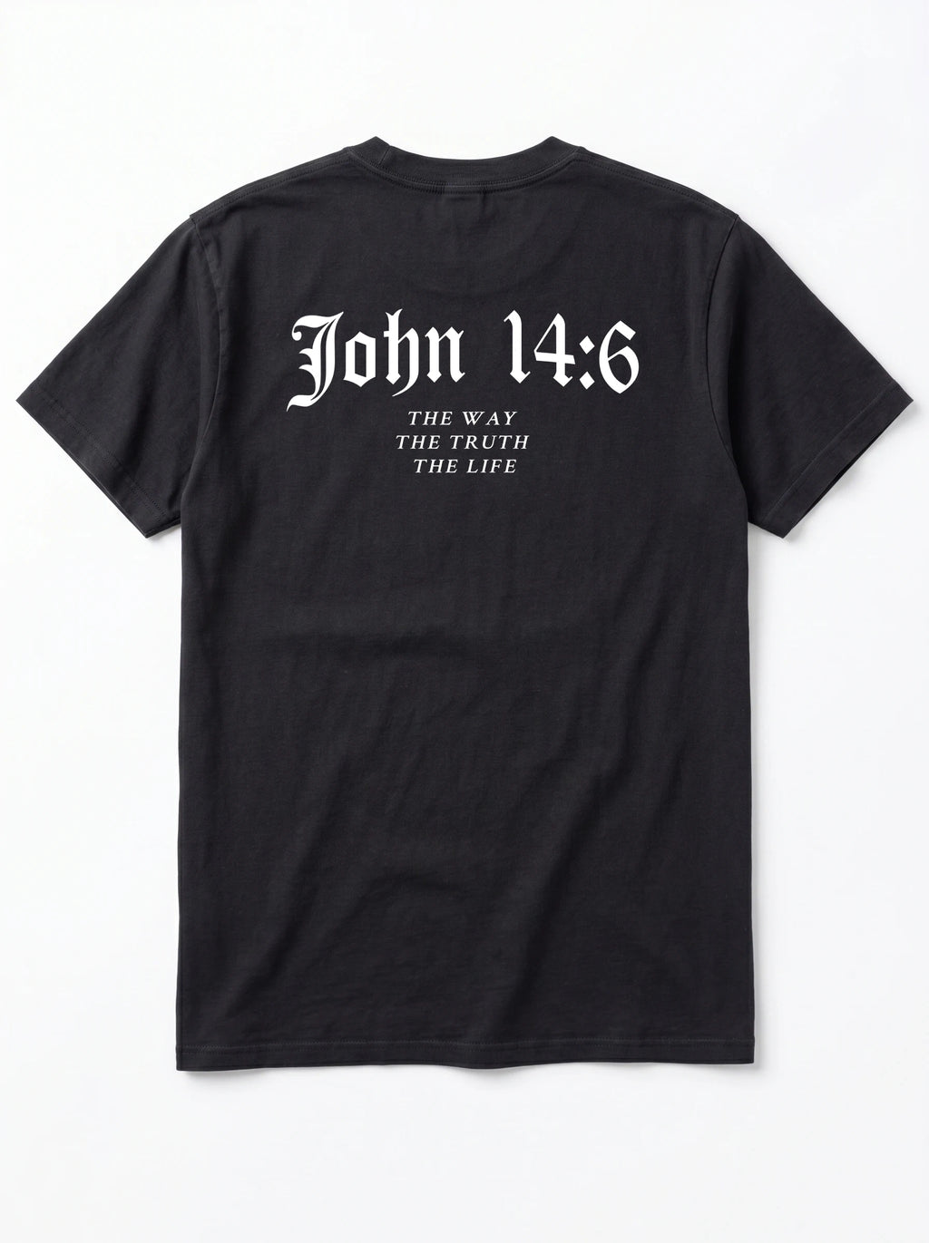 A black short-sleeve t-shirt shown from the back, featuring the text 'John 14:6' in a white Gothic font, with 'THE WAY THE TRUTH THE LIFE' printed below in a smaller serif font, on a light gray background.