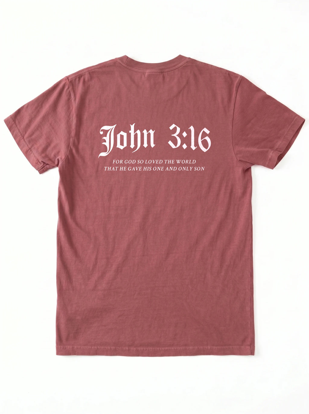 A dusty rose short-sleeve t-shirt shown from the back, featuring the text 'John 3:16' in a white gothic font with a bible verse printed underneath.