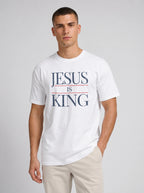 Man wearing white Comfort Colors Jesus Is King graphic t-shirt