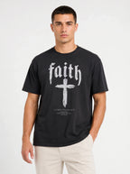 Person wearing a black T-shirt with “faith,” a large cross, and the text “1 Corinthians 16:13 — Be watchful. Stand firm in the faith. Be strong.”