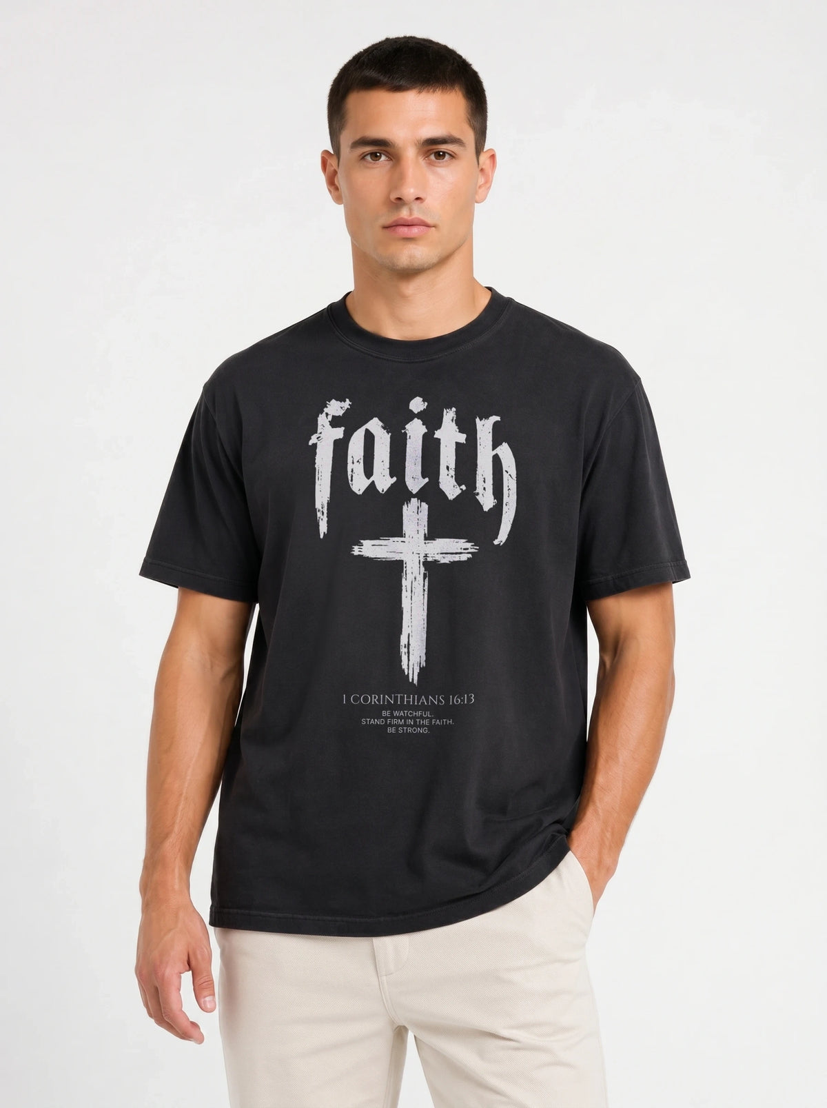 Person wearing a black T-shirt with “faith,” a large cross, and the text “1 Corinthians 16:13 — Be watchful. Stand firm in the faith. Be strong.”