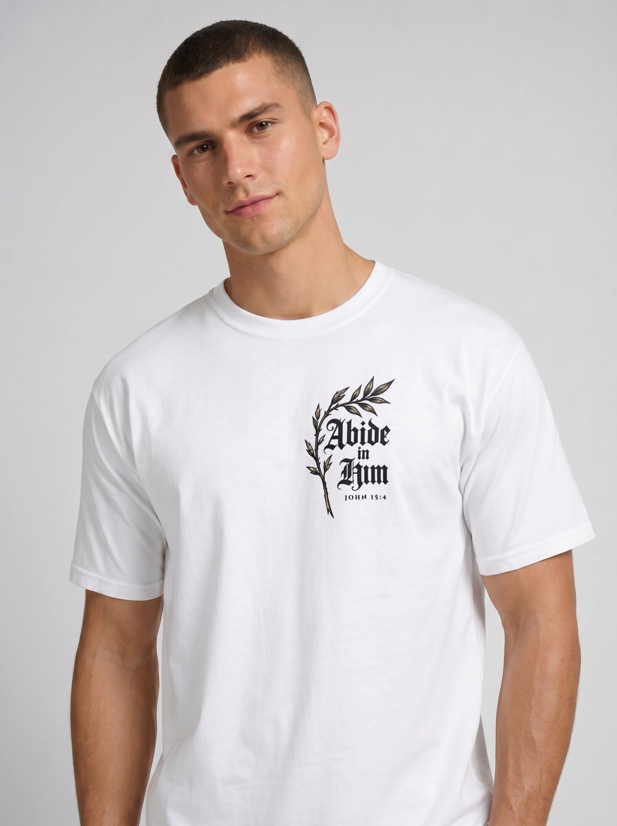 White T-shirt with a leafy chest graphic reading “Abide in Him” and “John 15:4.”