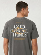 Person wearing a washed charcoal T-shirt with “Ephesians 4:6,” a large “God Over All Things” back graphic, and Bible verse text.