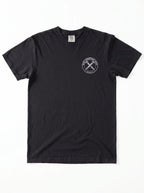A black short-sleeve crewneck t-shirt with a white circular graphic on the left side of the chest with the text 'IRON SHARPENS IRON' and 'PROVERBS 27:17' surrounding an illustration of two crossed nails, displayed flat against a white background.