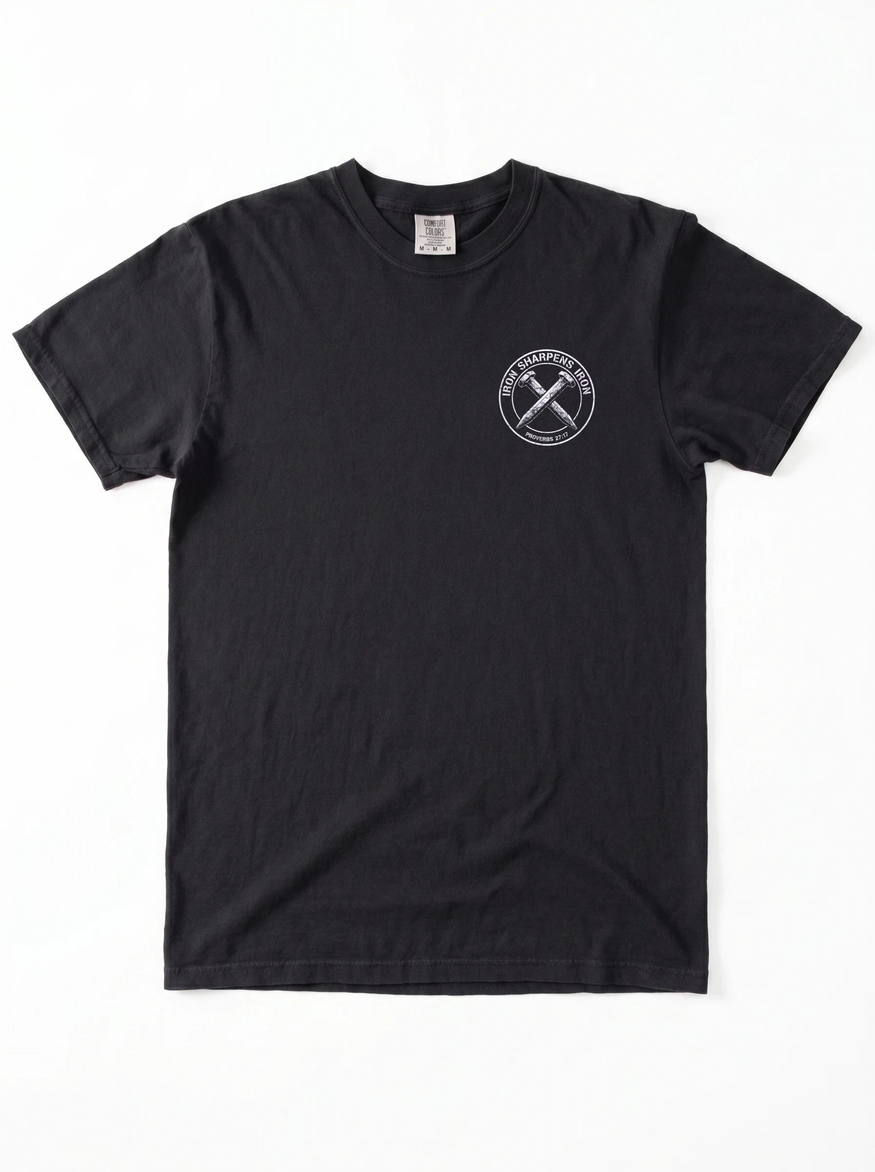 A black short-sleeve crewneck t-shirt with a white circular graphic on the left side of the chest with the text 'IRON SHARPENS IRON' and 'PROVERBS 27:17' surrounding an illustration of two crossed nails, displayed flat against a white background.
