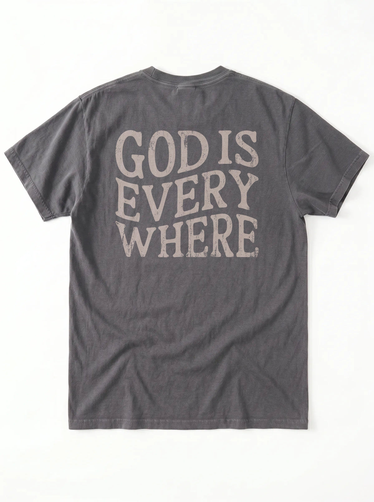 A dark gray crewneck t-shirt shown from the back, featuring the phrase 'GOD IS EVERY WHERE' printed in a distressed, light beige serif font.