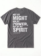 A dark gray crewneck t-shirt shown from the back, featuring a distressed white typographic print of the biblical quote 'NOT BY MIGHT NOR BY POWER, BUT BY MY SPIRIT -Zechariah 4:6' on a clean white background.