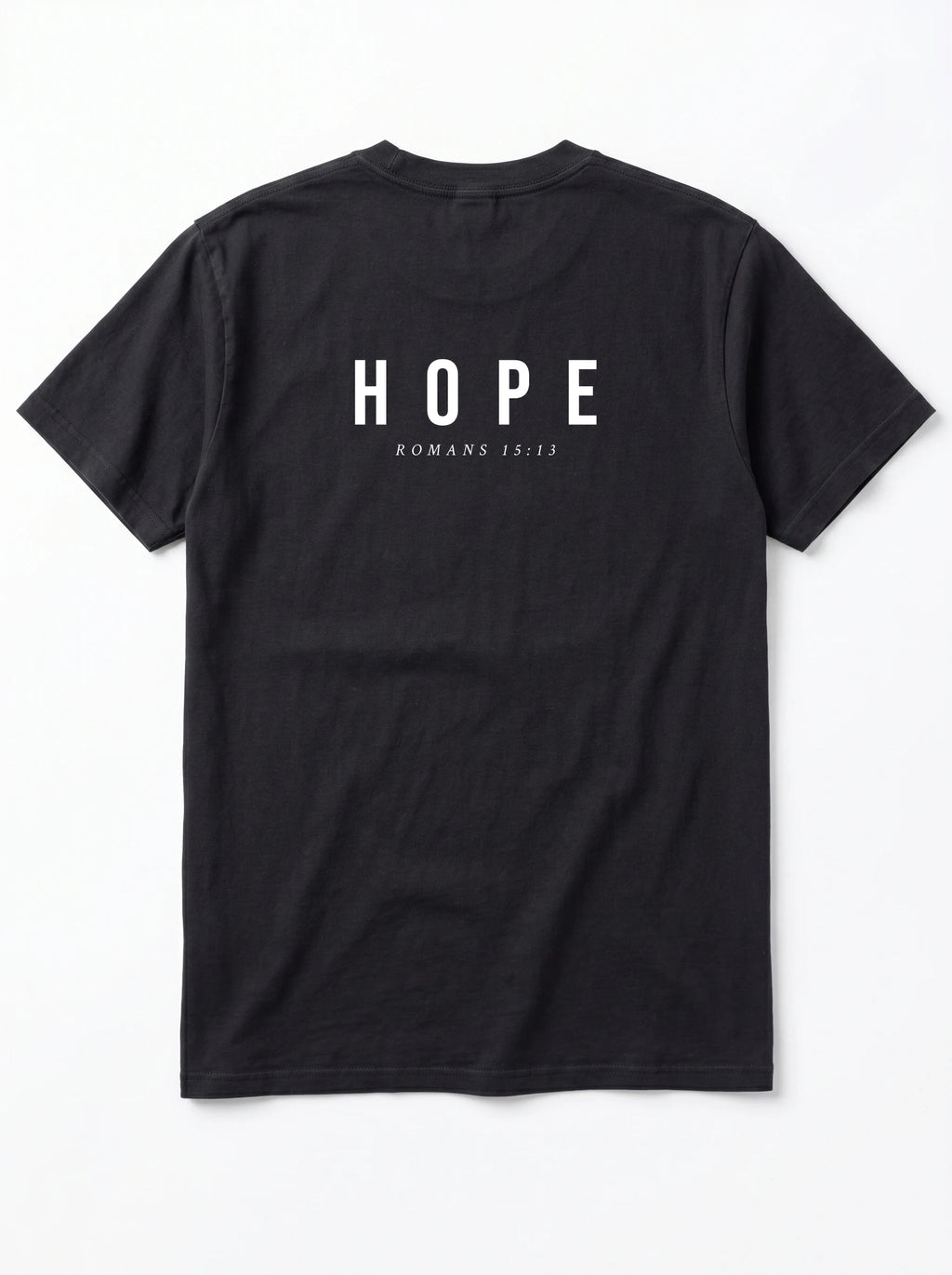 A black short-sleeve t-shirt shown from the back, featuring the word 'HOPE' printed in white capital letters with 'ROMANS 15:13' underneath, displayed on a clean white background.