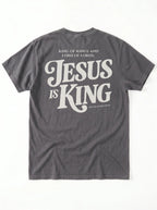 Back of a faded gray T-shirt with cream text: “King of Kings and Lord of Lords. Jesus is King. Revelation 19:16.”