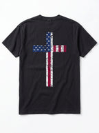 A black short-sleeve t-shirt shown from the back, featuring a large distressed cross graphic filled with the American flag pattern of stars and red and white stripes.
