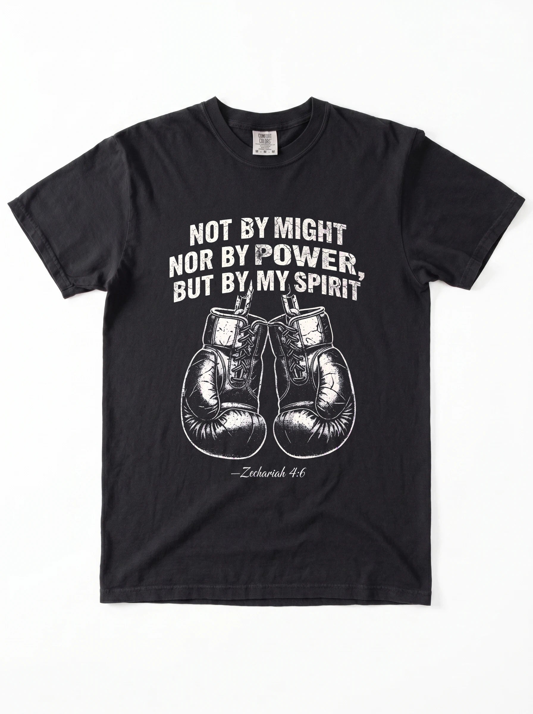 A black short-sleeve crewneck t-shirt featuring a white graphic print of a motivational quote from Jeremiah 4:6 above a pair of boxing gloves. The text reads 'NOT BY MIGHT NOR BY POWER, BUT BY MY SPIRIT'.
