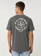 A man viewed from the back wearing a dark gray t-shirt with a white circular compass graphic and the text white circular graphic print on the back that reads 'IN ALL YOUR WAYS SUBMIT TO HIM' and 'PROVERBS 3:6'.