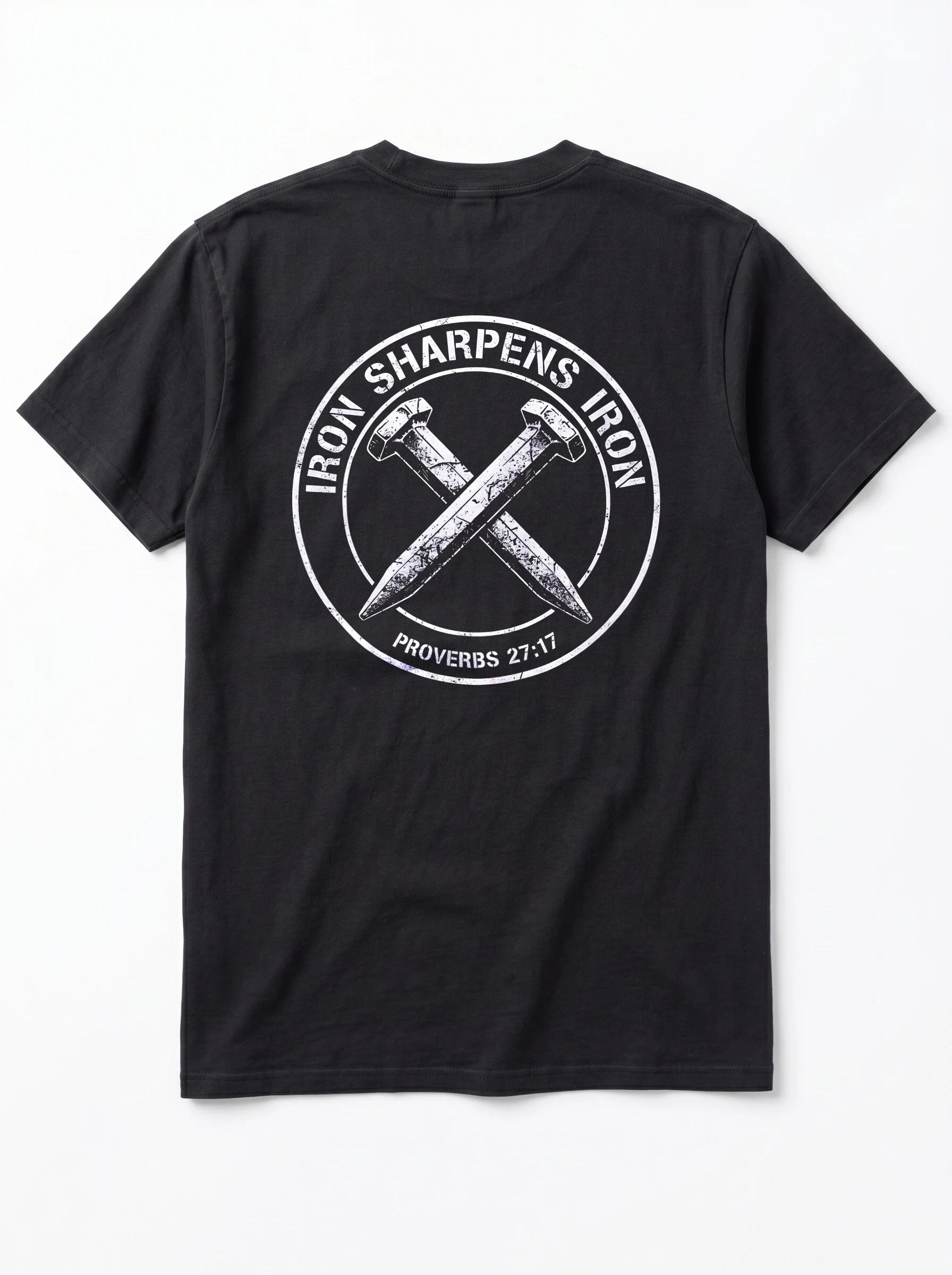A black short-sleeve t-shirt shown from the back, featuring a large white circular graphic with crossed nails and the text 'IRON SHARPENS IRON' and 'PROVERBS 27:17'.
