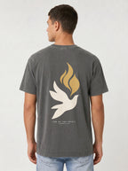 Person wearing a faded charcoal T-shirt with a large white dove, gold flames, and “LED BY THE SPIRIT ROMANS 8:14” on the back.