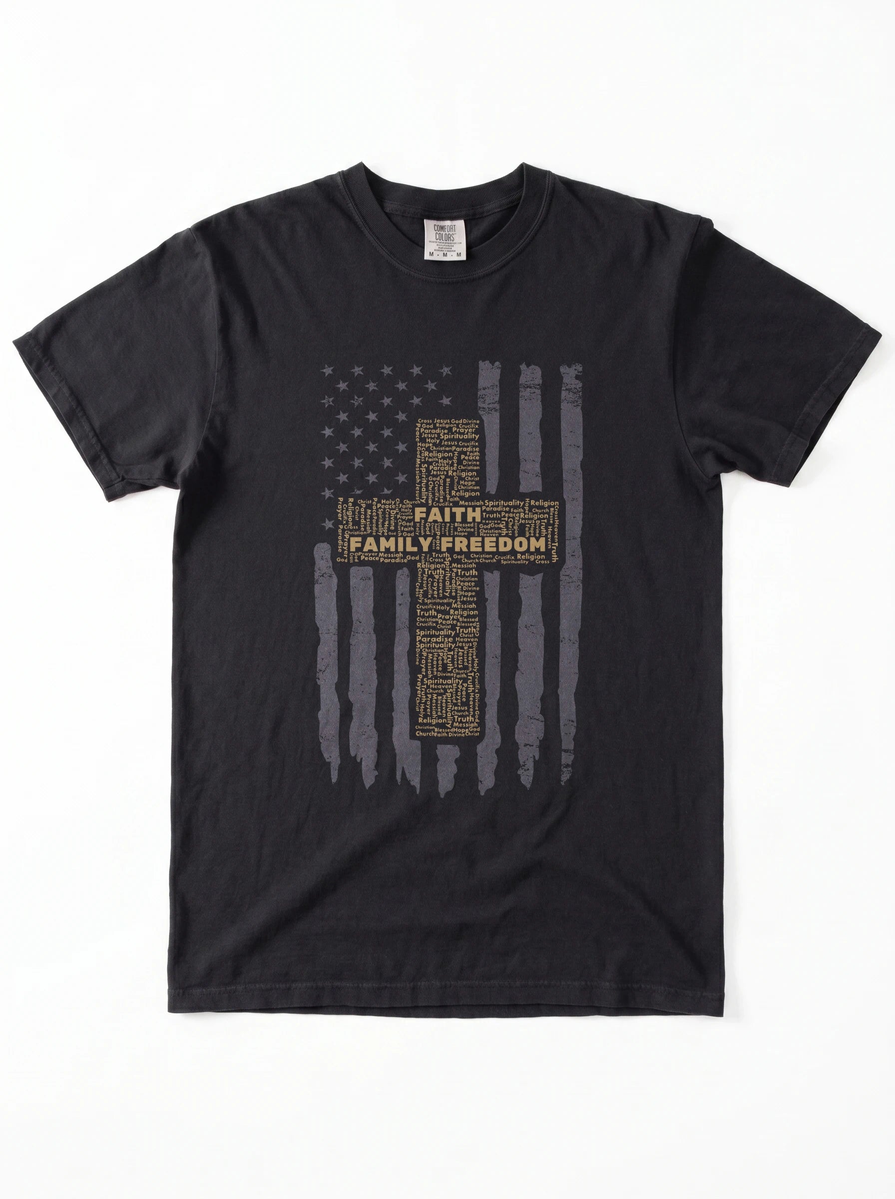 A black short-sleeve crewneck t-shirt featuring a distressed American flag graphic with a central cross made of text reading 'FAITH FAMILY FREEDOM' in gold and gray.