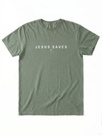 An olive green short-sleeve t-shirt with 'JESUS SAVES' printed in white across the chest, laid flat against a white background.