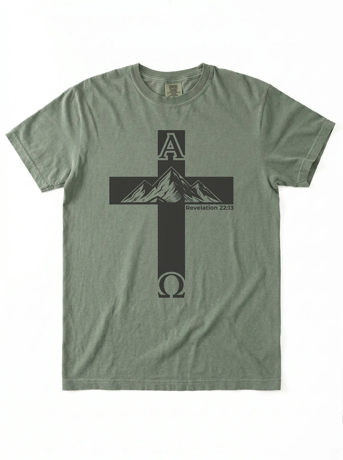 An olive green short-sleeve t-shirt with a black graphic of a cross containing a mountain peak and the Greek letters Alpha and Omega, on a white background.