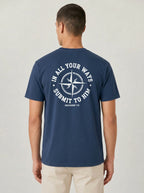 A man viewed from the back wearing a navy blue t-shirt with a white circular graphic on the back that reads 'IN ALL YOUR WAYS SUBMIT TO HIM' and 'PROVERBS 3:6'.
