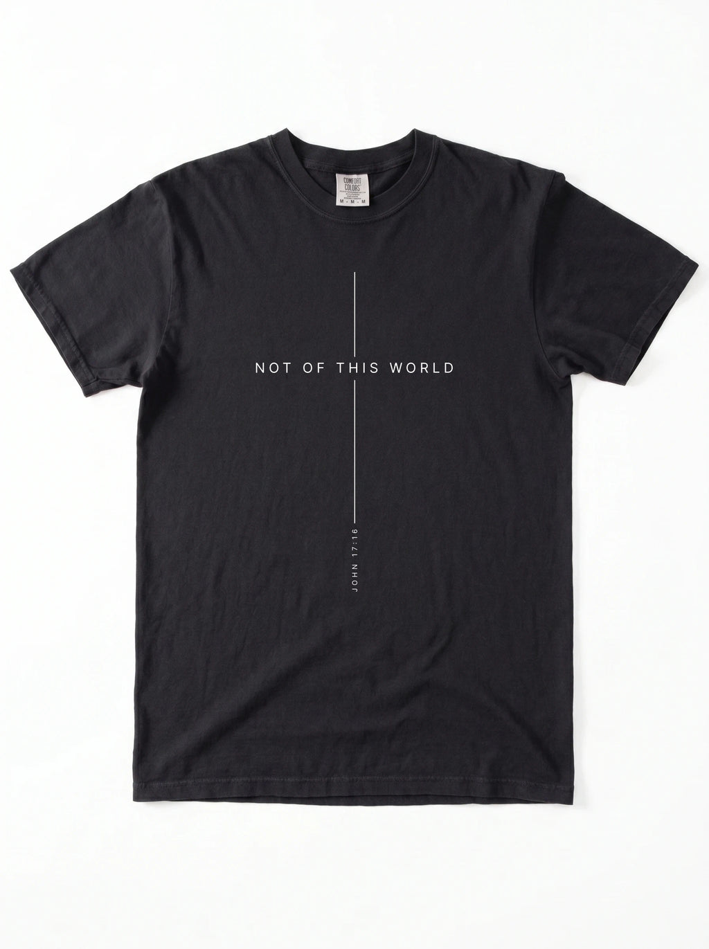 Black T-shirt laid flat with thin white lines framing the text “Not of This World” and “John 17:16.”
