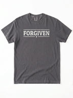 A dark gray crewneck t-shirt with 'FORGIVEN' printed in white block letters across the chest, flanked by two horizontal lines and a small cross in the center, shown flat on a white background.