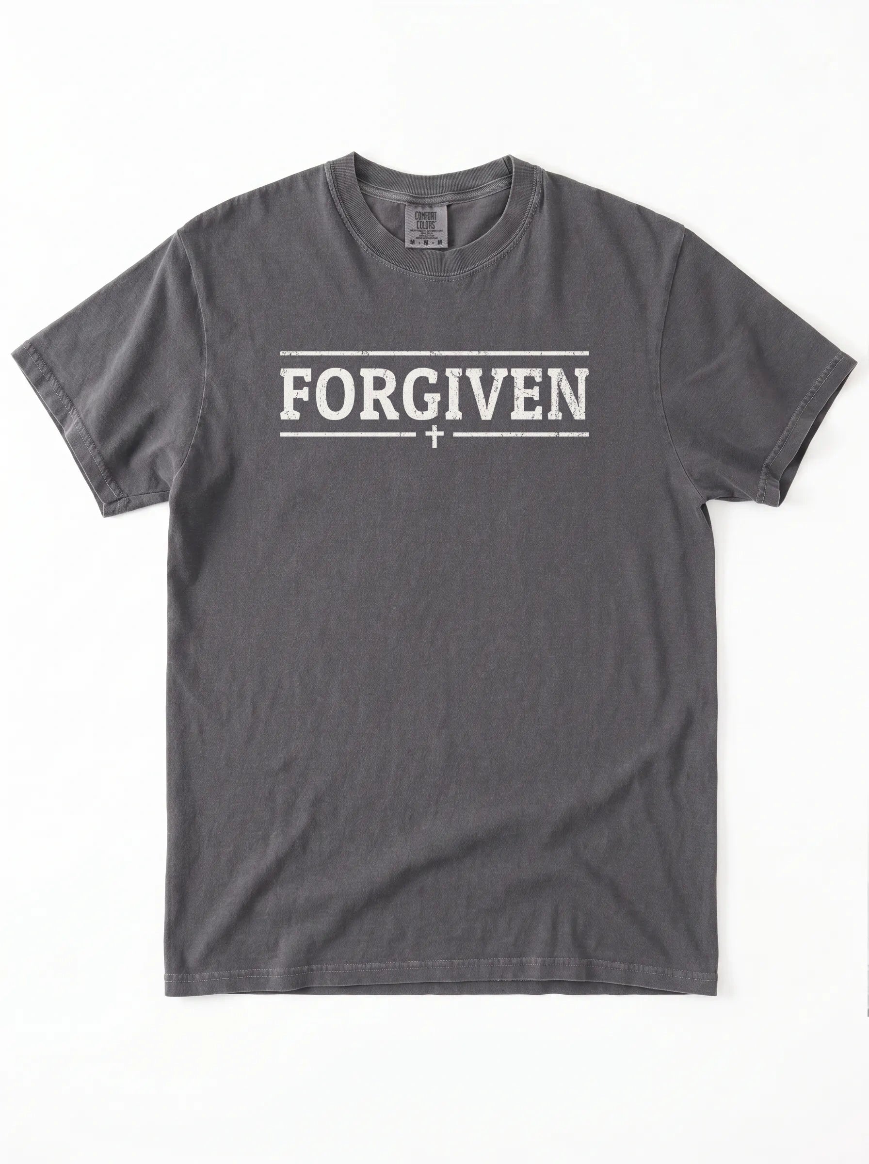 A dark gray crewneck t-shirt with 'FORGIVEN' printed in white block letters across the chest, flanked by two horizontal lines and a small cross in the center, shown flat on a white background.