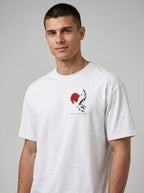 Person wearing a white T-shirt with a black-and-white flying bird against a red circle and “LED BY THE SPIRIT” on the chest.