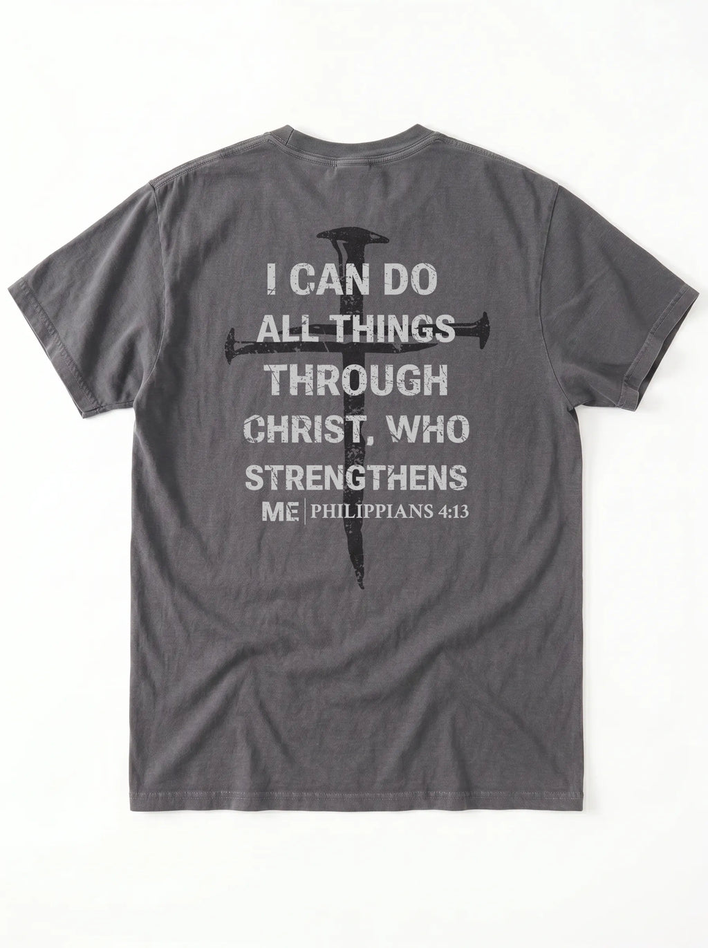 A dark gray crewneck t-shirt shown from the back, featuring a distressed white text graphic of the biblical quote 'I CAN DO ALL THINGS THROUGH CHRIST, WHO STRENGTHENS ME' alongside a black cross design.