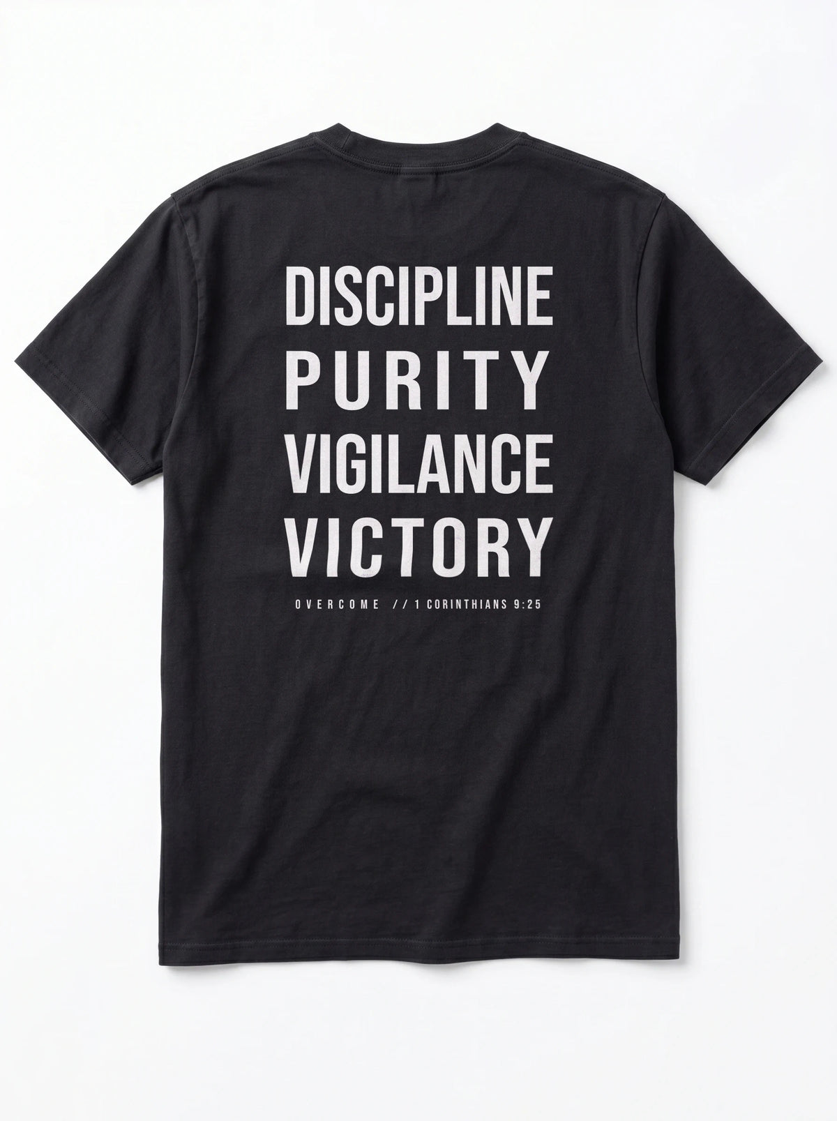 Back of a black T-shirt laid flat, reading “Discipline Purity Vigilance Victory” and “Overcome // 1 Corinthians 9:25.”