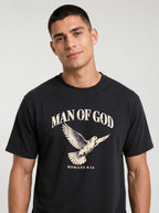 Close-up of a person wearing a black T-shirt with a flying dove and the text “Man of God” and “Romans 8:14.”