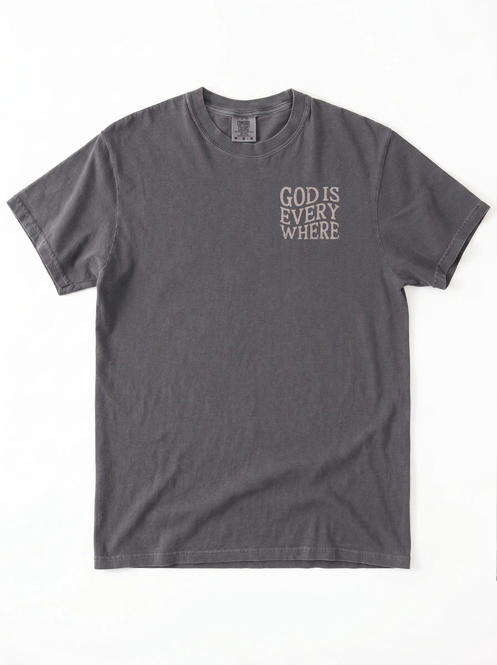 A dark gray short-sleeve t-shirt with the phrase 'GOD IS EVERY WHERE' printed in a light gray or off-white typewriter font on the left chest, displayed flat against a white background.