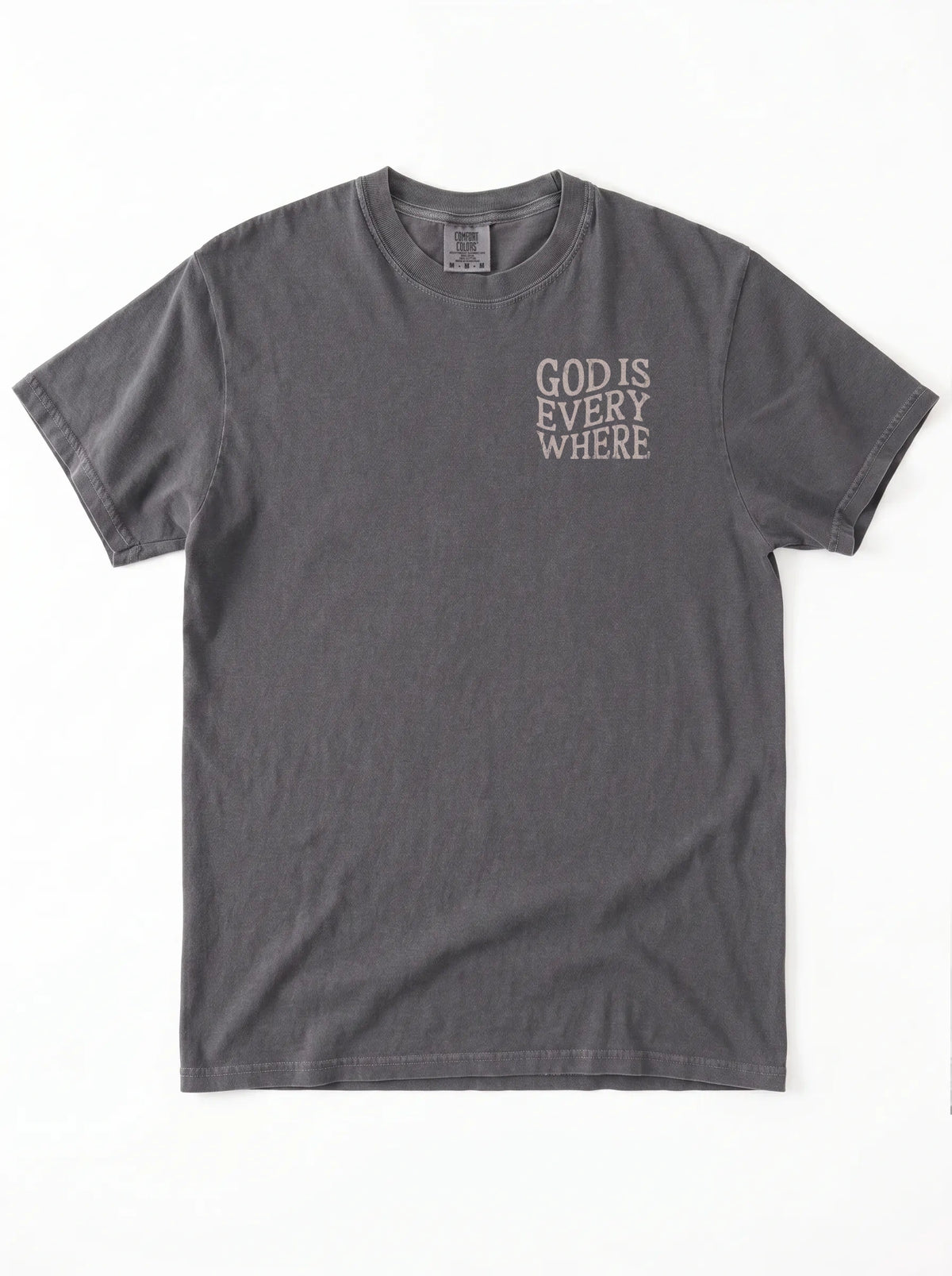 A dark gray short-sleeve t-shirt with the phrase 'GOD IS EVERY WHERE' printed in a light gray or off-white typewriter font on the left chest, displayed flat against a white background.