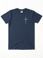A navy blue short-sleeve crewneck t-shirt with a small, distressed cross graphic on the left chest, laid flat against a white background.