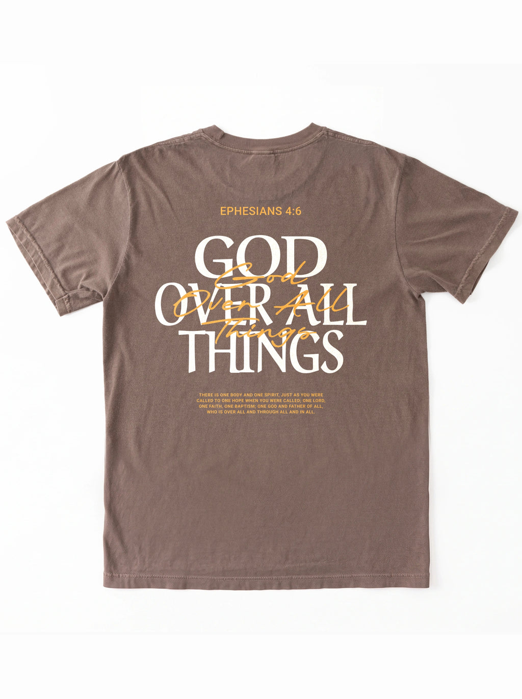 Back of a brown T-shirt laid flat, featuring “Ephesians 4:6,” a large “God Over All Things” graphic, and Bible verse text.