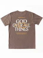 Back of a brown T-shirt laid flat, featuring “Ephesians 4:6,” a large “God Over All Things” graphic, and Bible verse text.