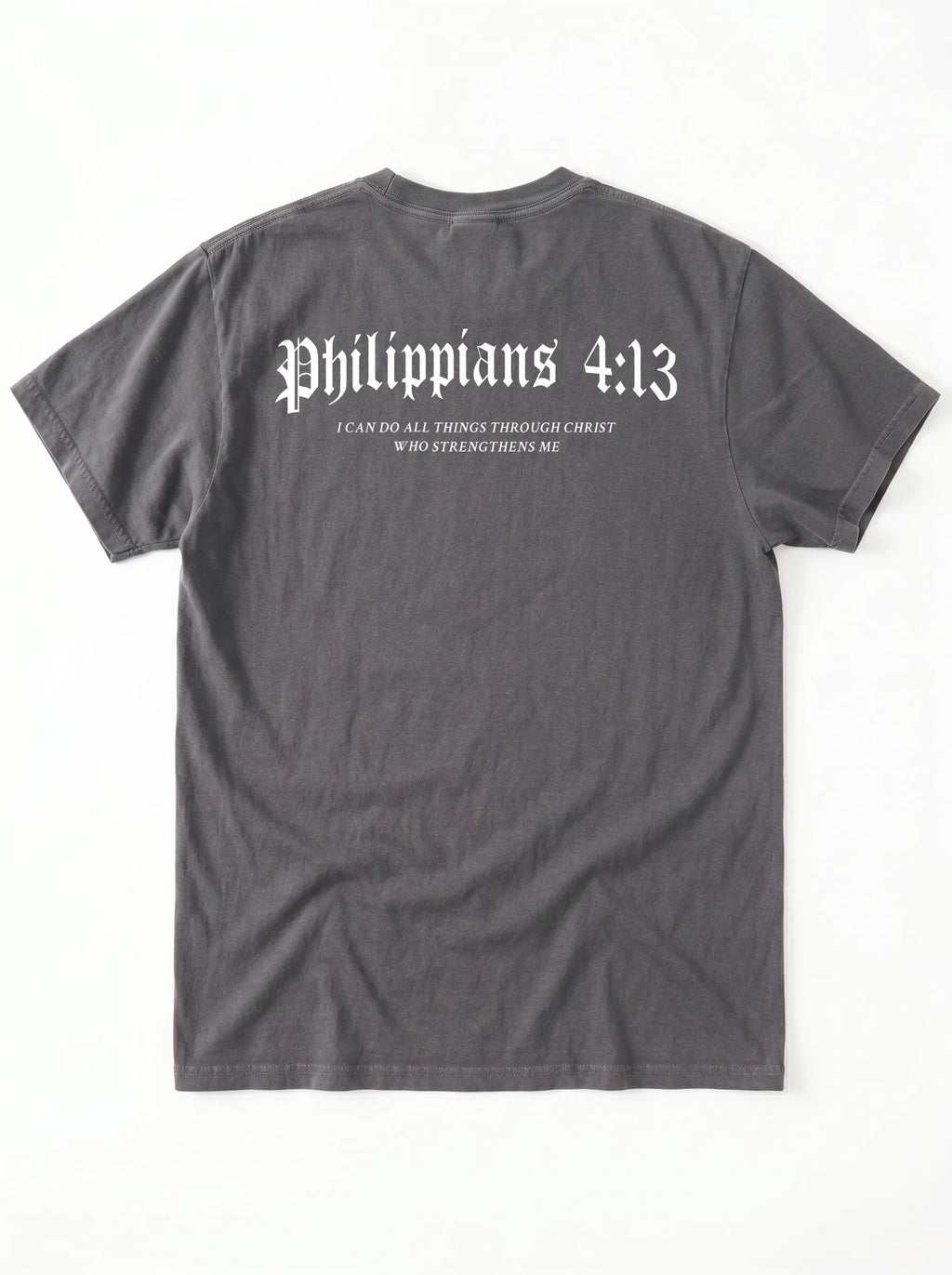 A dark gray t-shirt shown from the back, featuring the text 'Philippians 4:13' in a white gothic font, with smaller text underneath reading 'I CAN DO ALL THINGS THROUGH CHRIST WHO STRENGTHENS ME'.
