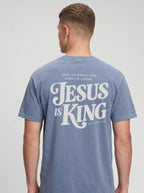 Person wearing a faded light blue T-shirt with back text: “King of Kings and Lord of Lords. Jesus is King. Revelation 19:16.”