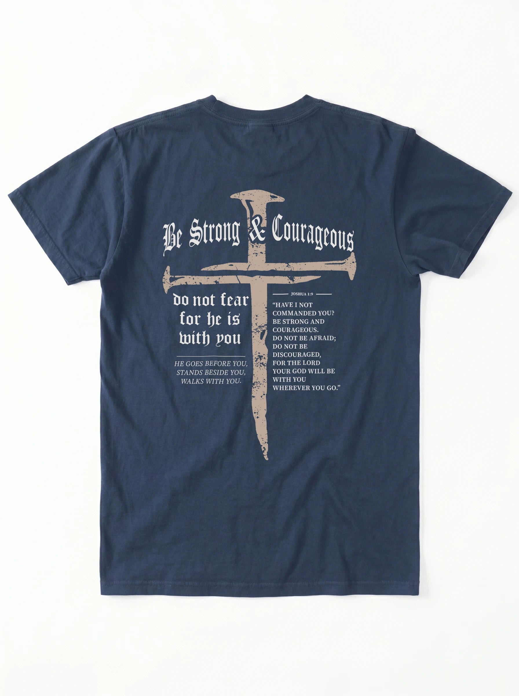 A navy blue short-sleeve t-shirt shown from the back, featuring a large graphic print with a cross, the words 'Be Strong & Courageous', and Bible verses printed in white and light gray.