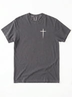 Gray T-shirt laid flat with a small white cross printed on the chest.